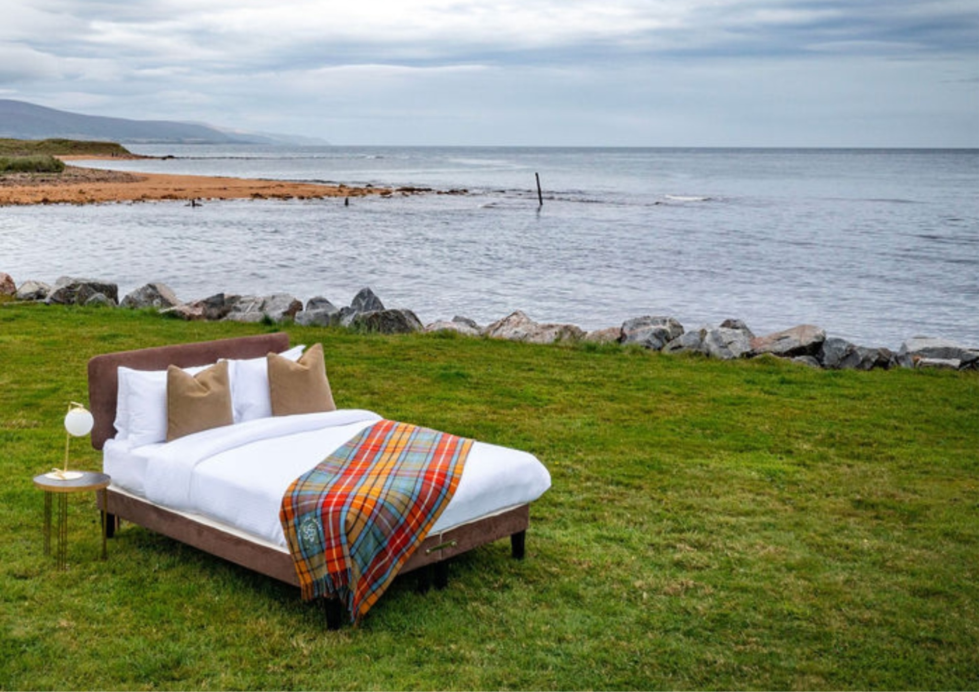 A Highland BlindCraft bed styled with tartan throw on the Scottish coast